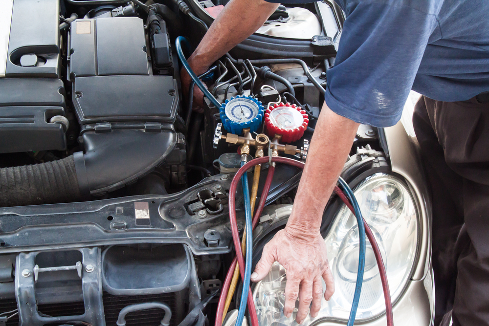 mechanic-inspecting-used-car